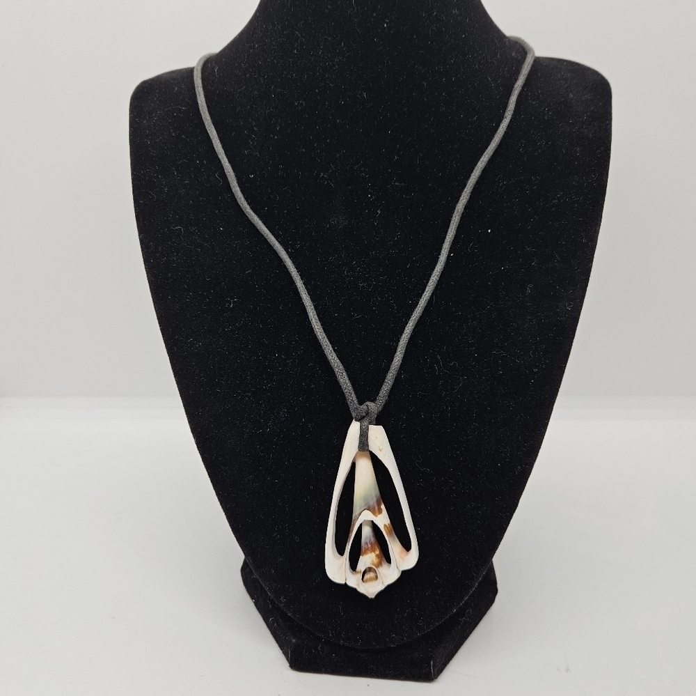 shell cross-section pendant on black cord